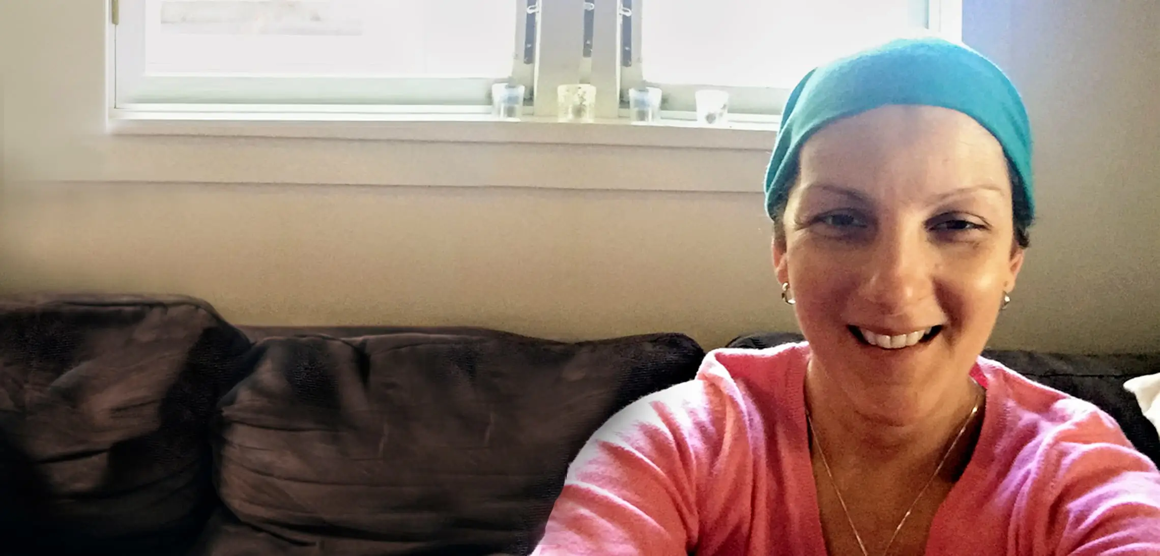 Jacqui taking a selfie and smiling from the hospital room