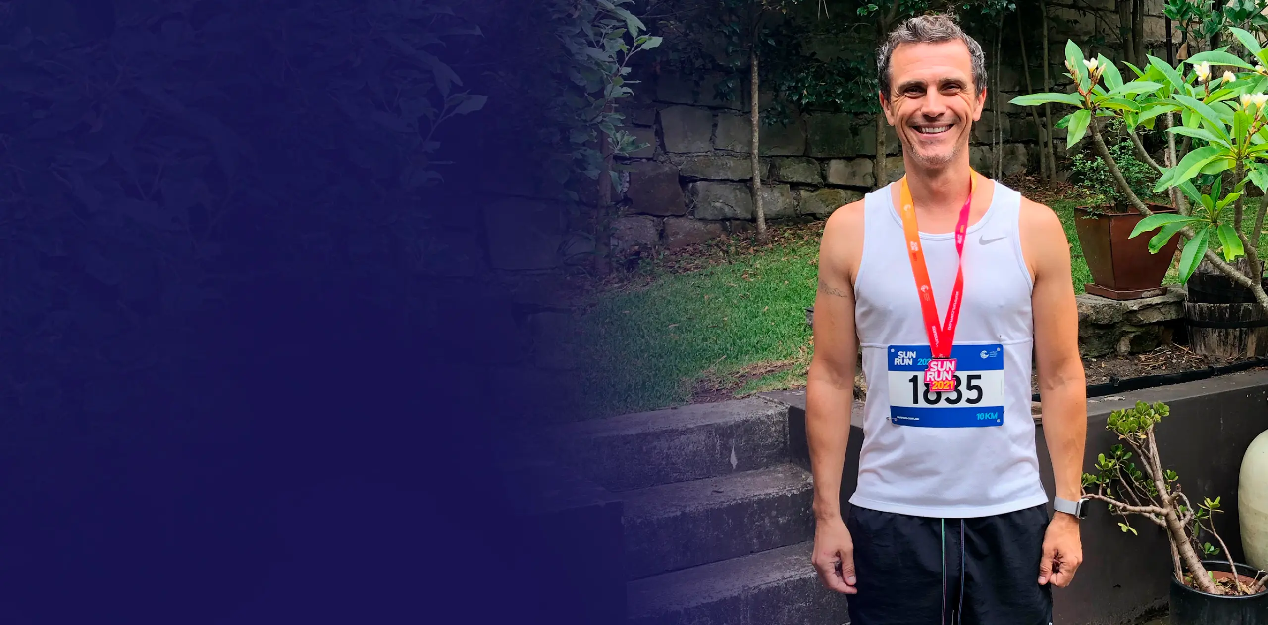 Simon before cancer smiling after running a marathon